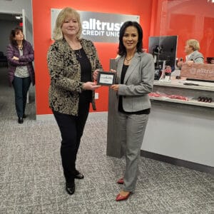 Woman handing award over in picture