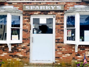 Business front door with brick exterior